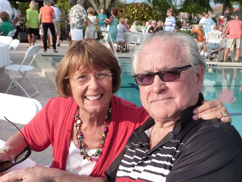 Smiling elderly couple enjoying a sunny day outdoors.