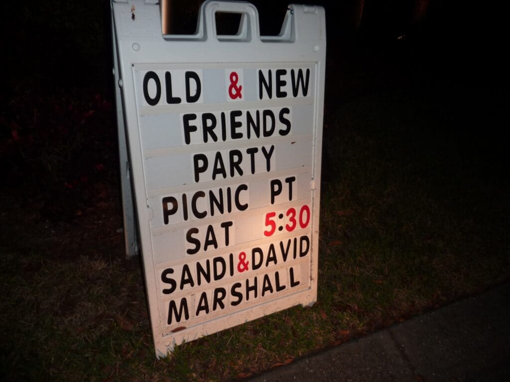 Sign announcing an Old & New Friends Party picnic event.